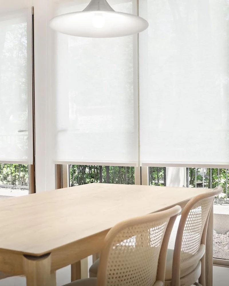 Sunscreen roller blind above a dining table